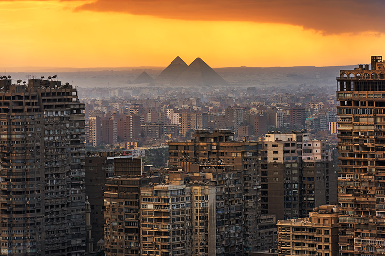 Egypt faces power outages, with a view of Cairo and the pyramids in the distance.