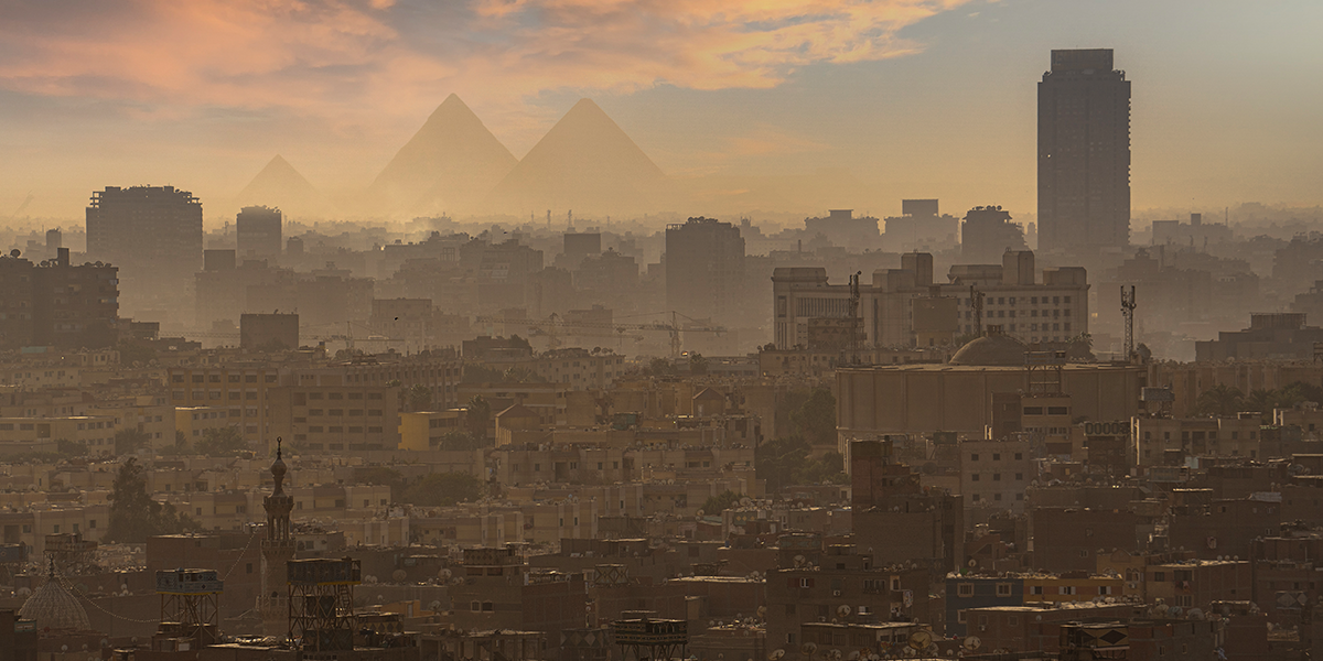 Cairo's skyline with the Egyptian pyramids in the distance.
